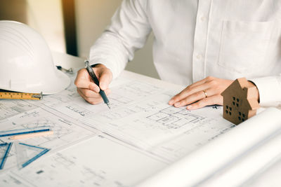 Midsection of man working on table