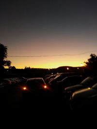 Cars on road at sunset