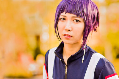 Portrait of young woman standing outdoors