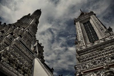 Low angle view of buildings against cloudy sky