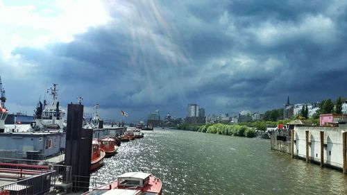 Bridge over river against cloudy sky