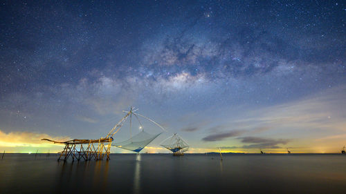 Milky way and square dip nets in lake at pakpra, phatthalung, thailand