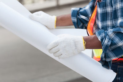 Midsection of man standing by railing