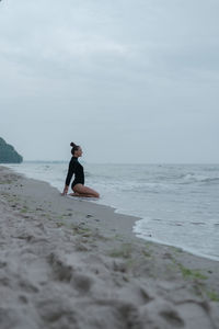 Full length of man on beach against sky