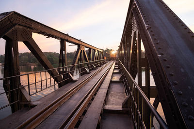 Railway bridge against sky at sunset