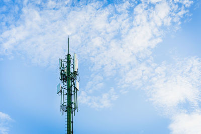 Low angle view of communications tower against sky