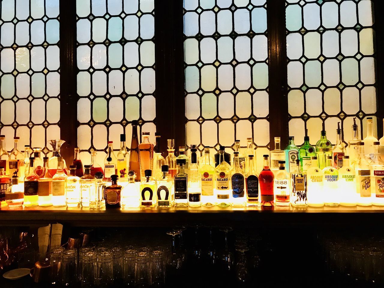 VIEW OF GLASS OF BOTTLES IN BAR