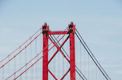 Low angle view of suspension bridge against sky