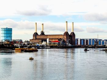 Boats in river with buildings in background