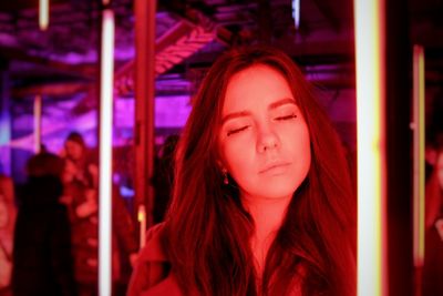 Portrait of beautiful young woman looking away