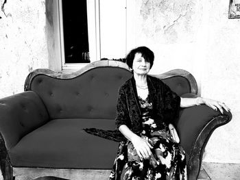 Portrait of smiling young woman sitting outdoors