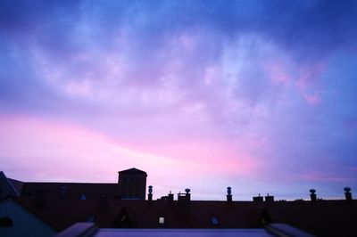 Silhouette city against sky at sunset