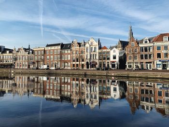 Reflection of buildings in lake against sky