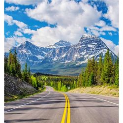 Road leading towards mountains against sky