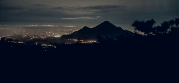 Scenic view of silhouette mountains against sky during sunset