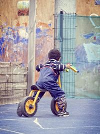 Full length of boy jumping on street