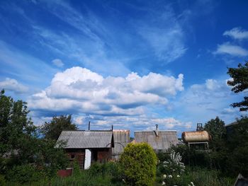 Houses and trees against blue sky