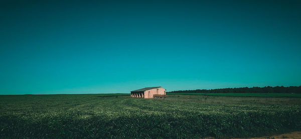 Barn on field against clear sky