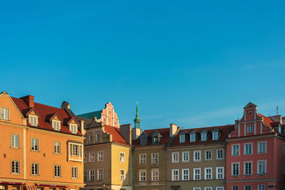 Low angle view of buildings against blue sky