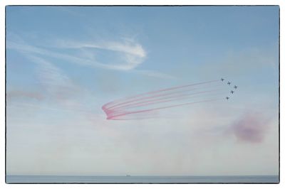 Low angle view of airplane flying against sky