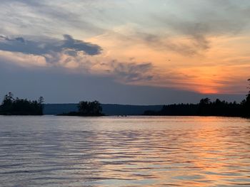 Scenic view of lake against sky during sunset