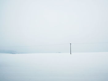 Snow covered landscape against sky