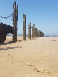 Scenic view of beach against clear blue sky