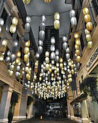 Low angle view of illuminated chandelier hanging on ceiling