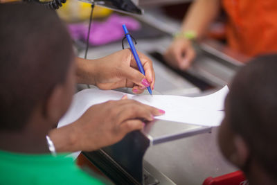 Customer signing a bill in a shopping mall