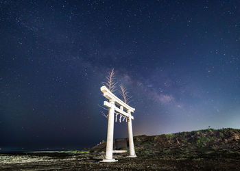 Information sign against sky at night