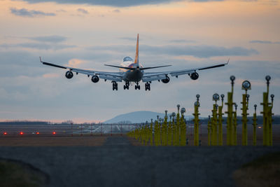 Airplane flying over airport runway