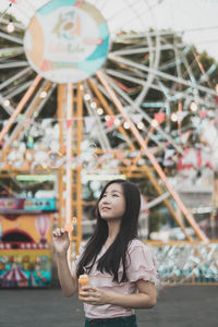 Portrait of a smiling young woman in amusement park