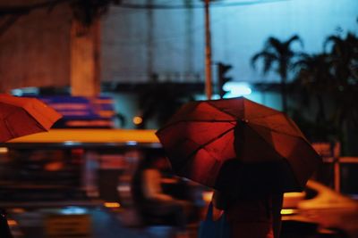 Red holding umbrella