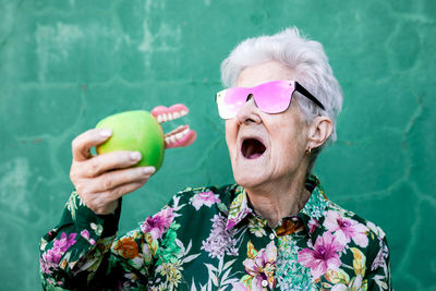 Portrait of woman holding fruits