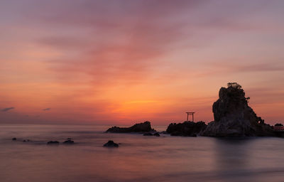 Scenic view of sea against orange sky