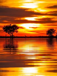 Scenic view of lake against romantic sky at sunset