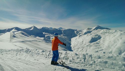 Man skiing on snowcapped mountains during winter