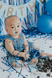 High angle view of cute boy playing with balloons