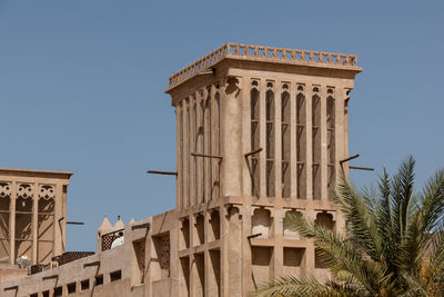 Low angle view of historical building against clear blue sky