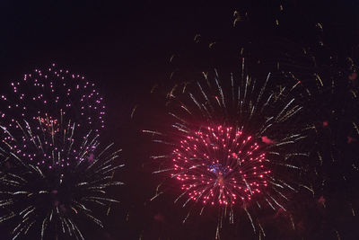 Low angle view of firework display at night