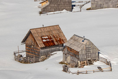 High angle view of buildings on snow covered field