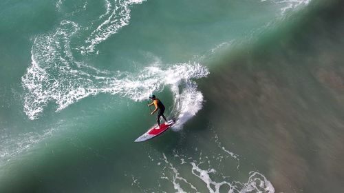 High angle view of man surfing in sea/colours on the wave