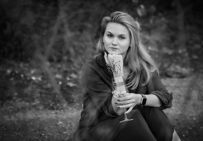 Portrait of a beautiful young woman drinking glass