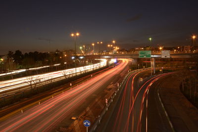 High angle view of light trails on highway at night