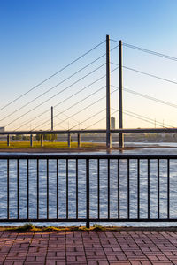 Bridge over river against clear blue sky