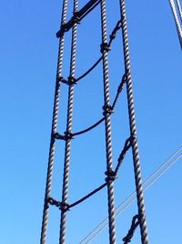 Low angle view of cables against clear blue sky