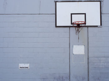 Basketball hoop against brick wall