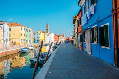 Canal amidst buildings against sky