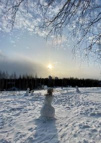 Scenic view of snow covered field against sky