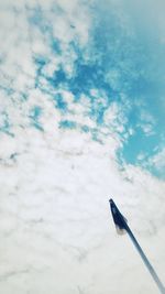 Low angle view of bird perching on blue sky